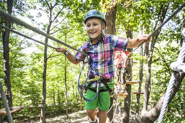 ToDoOntario - Treetop Trekking, boy doing treewalk