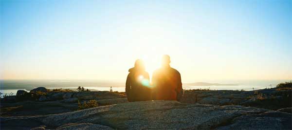 ToDoOntario, couple on rock watching sunrise or sunset