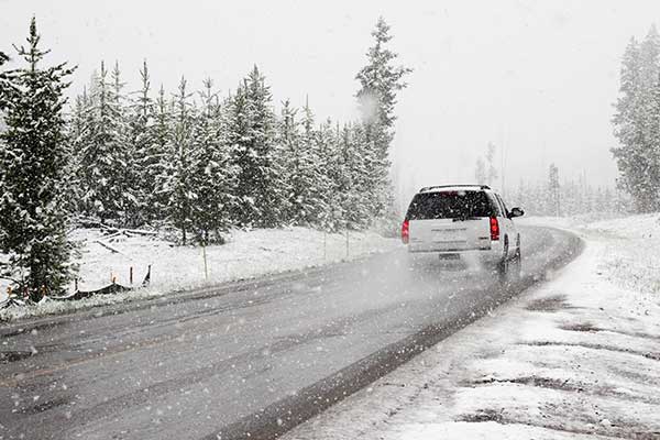 SUV driving on a snowy road